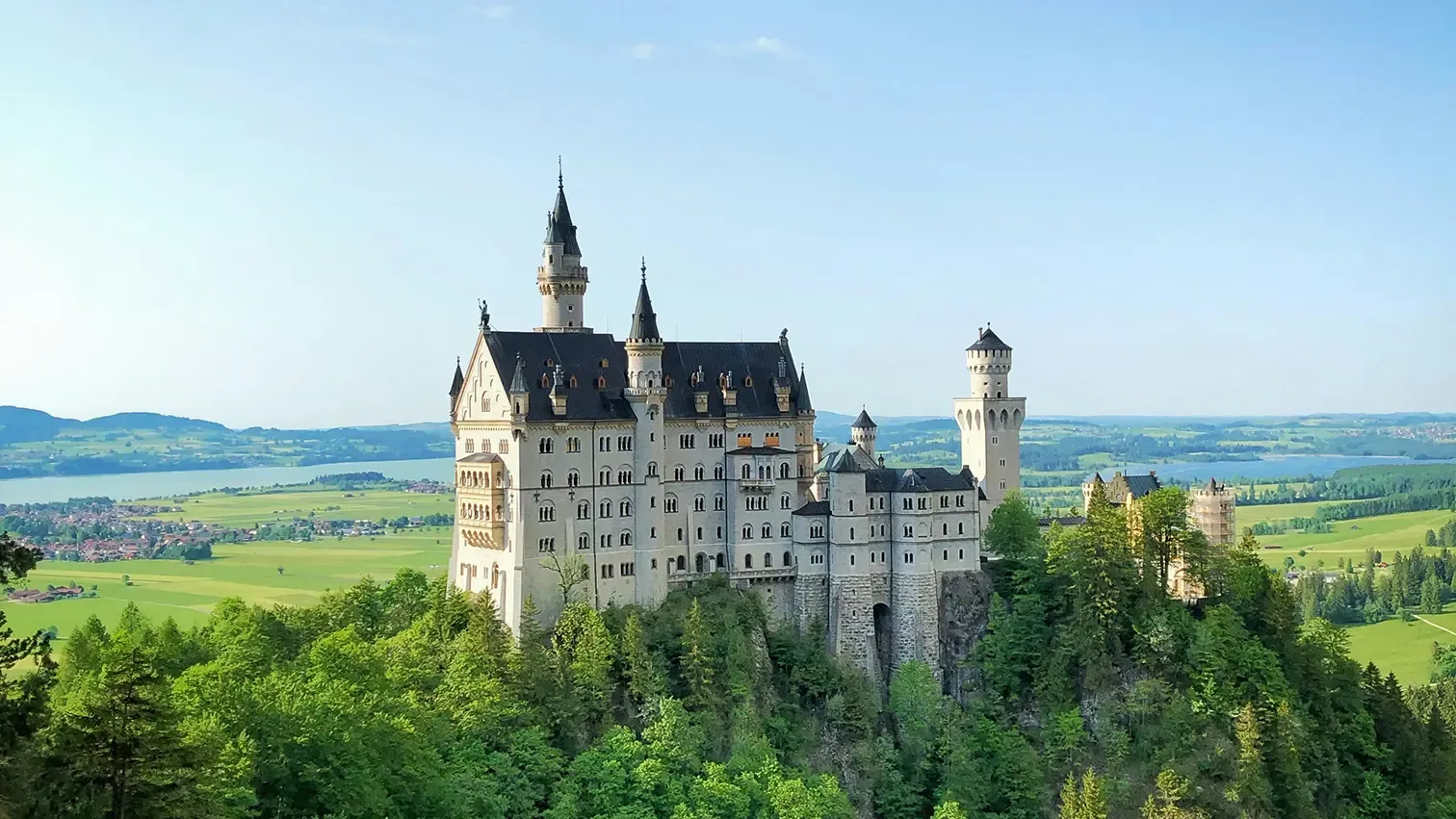 Neuschwanstein Castle, Bavaria, Germany. Photo by <a href="https://unsplash.com/@malyushev?utm_content=creditCopyText&utm_medium=referral&utm_source=unsplash">Victor Malyushev</a> on <a href="https://unsplash.com/photos/white-castle-on-top-of-the-mountain-surrounded-with-trees-9Ziy3r0itK4?utm_content=creditCopyText&utm_medium=referral&utm_source=unsplash">Unsplash</a>